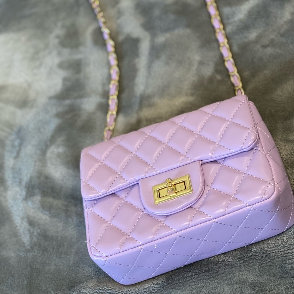 Small (7 1/2” x 5 1/2”) lilac crossbody bag, no brand.